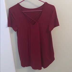 Red top with cut outs showing mild cleavage